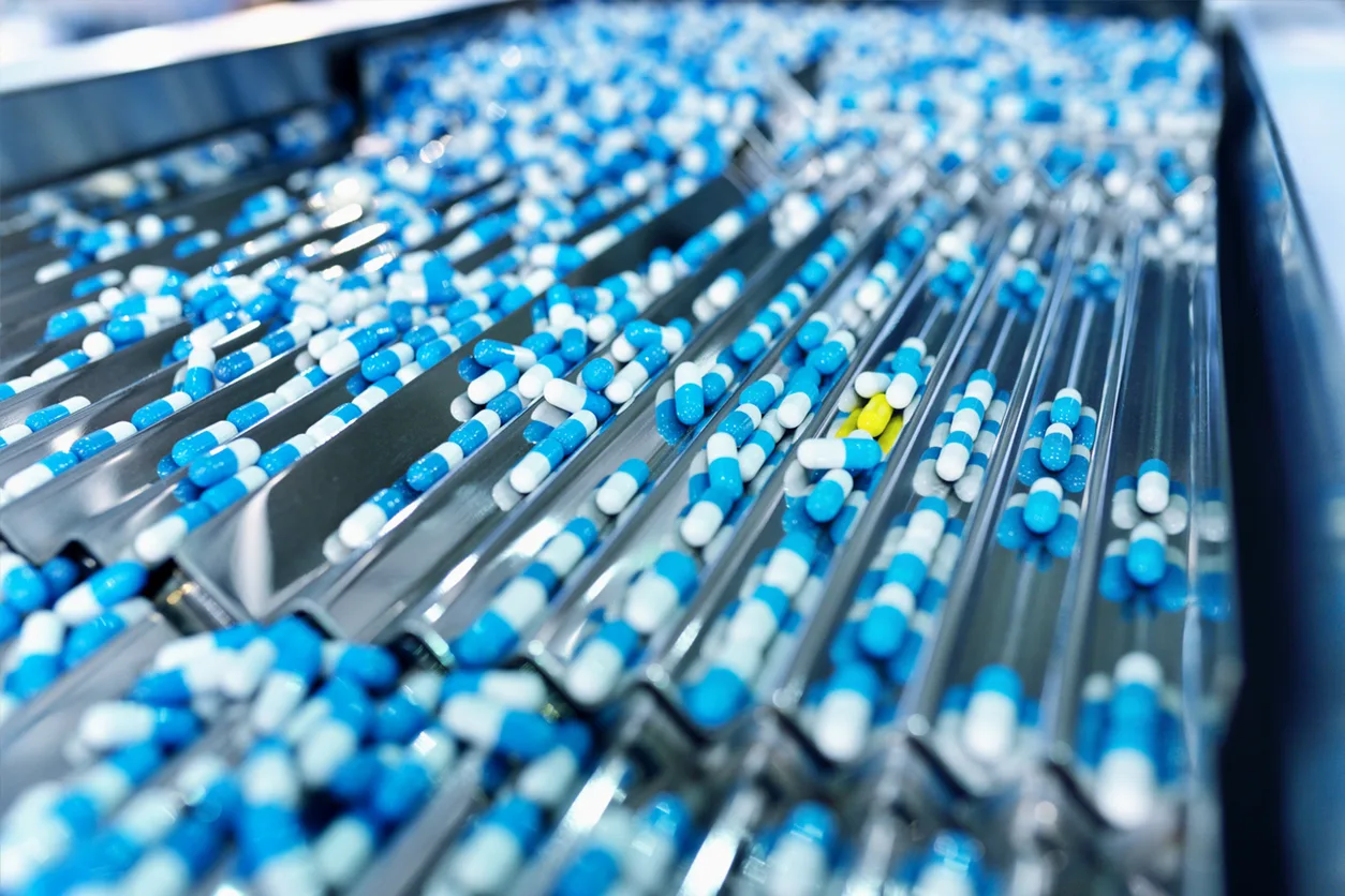 Pill capsules on a production line.