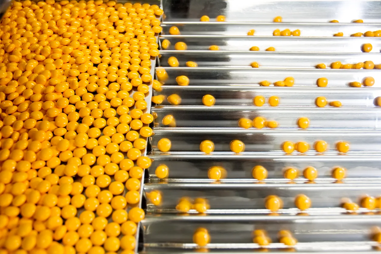 Yellow pills on a production line.